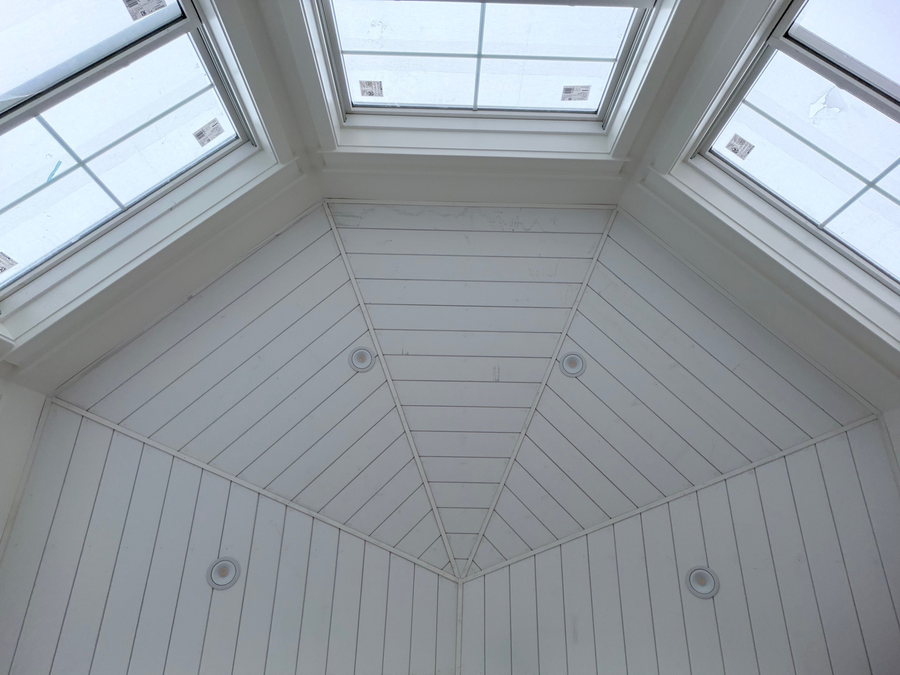 Octagonal shiplap ceiling ringed with windows