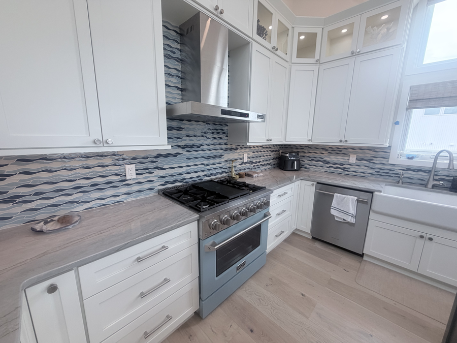 Kitchen range wall with tile backsplash and a blue range
