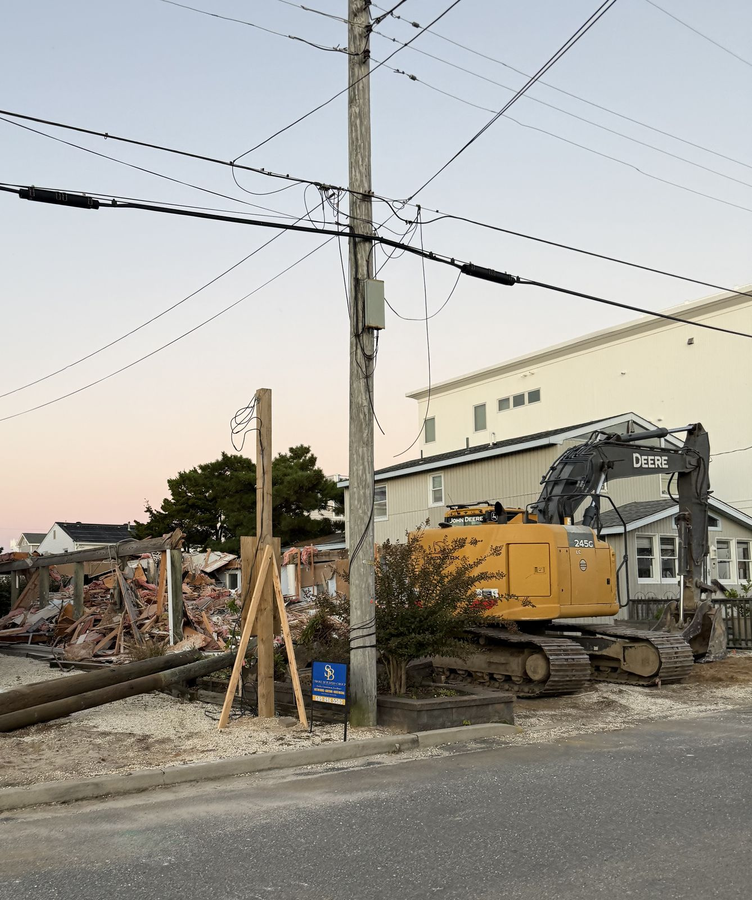 An excavator on the lot as demolition of the existing house wraps up