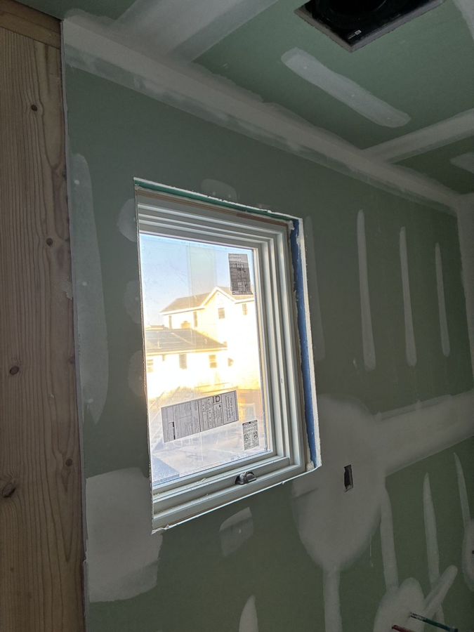 Green-board drywall around a bathroom window