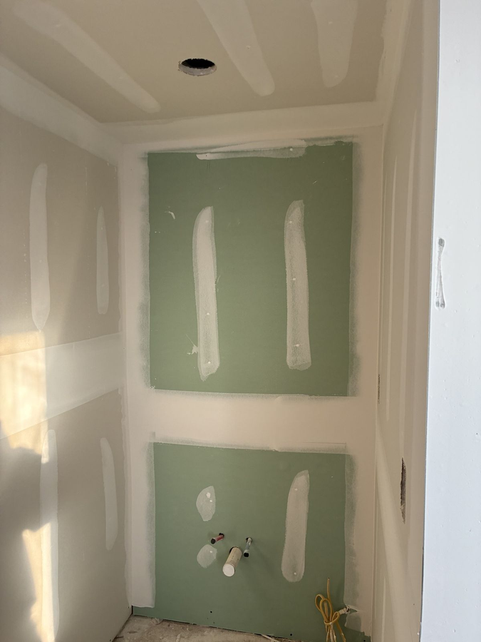 Drywall taped and mudded in a bathroom