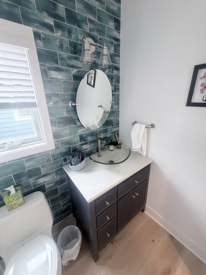 Powder room vanity and round mirror