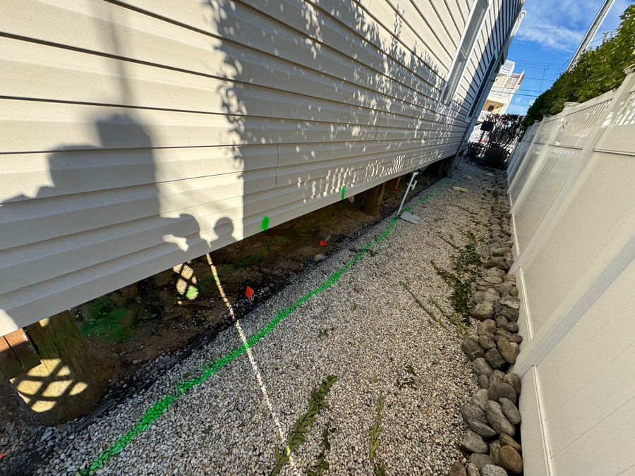 Along the side of the existing house