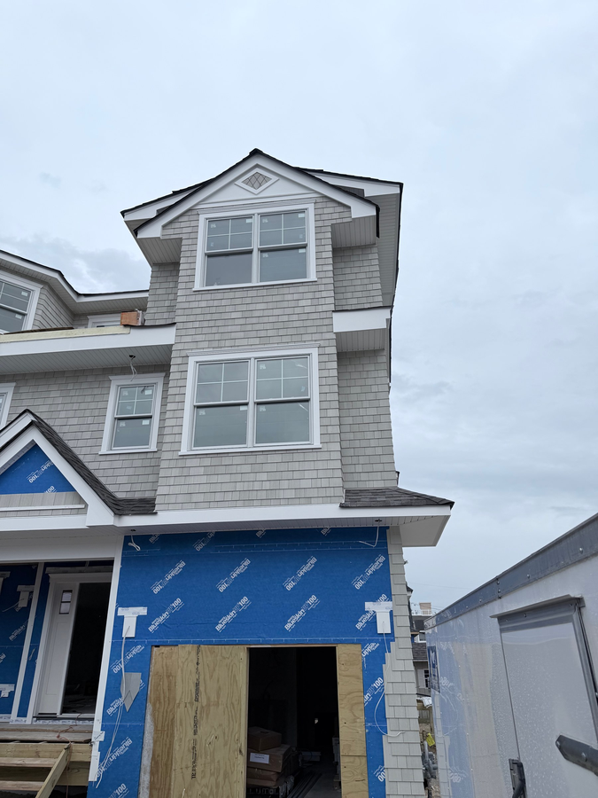 Shingle siding going on