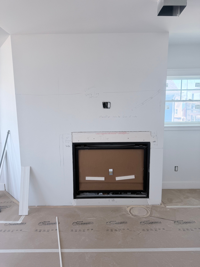 The fireplace before its surround