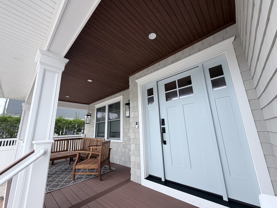 The covered porch and pale blue front door