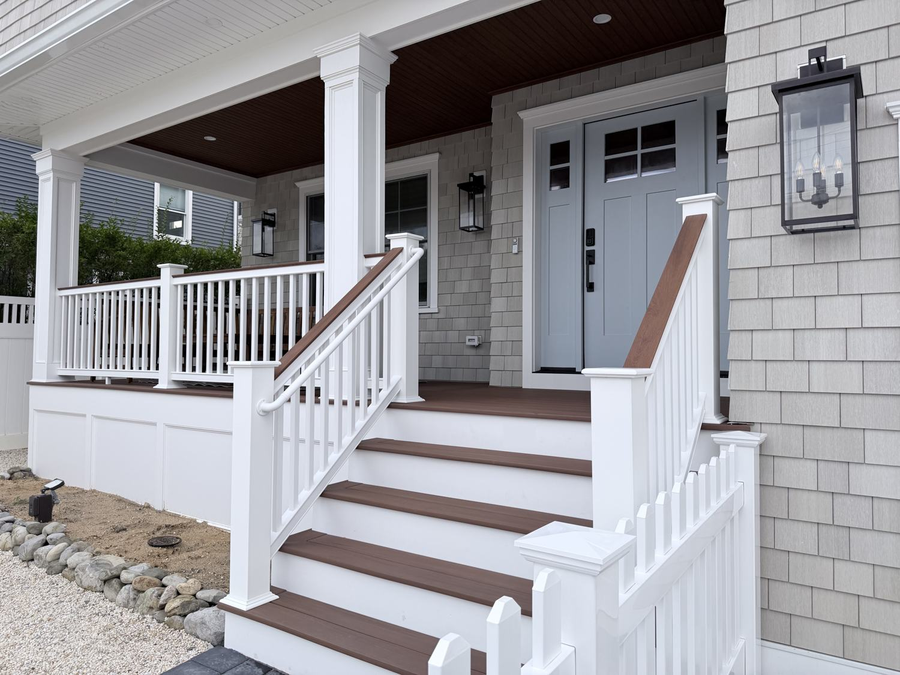 Front steps with white rails and wood-tone treads
