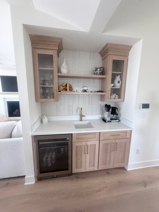 The wet bar with glass-front cabinets
